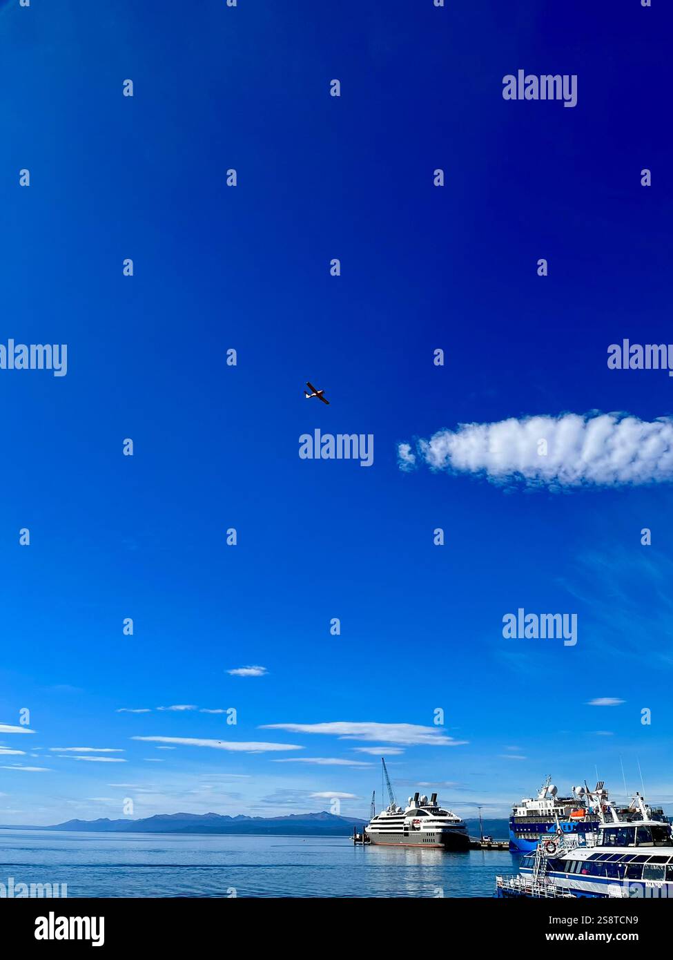 A plane hovering on Ushuaia's port - Smartphone Captured Stock Image