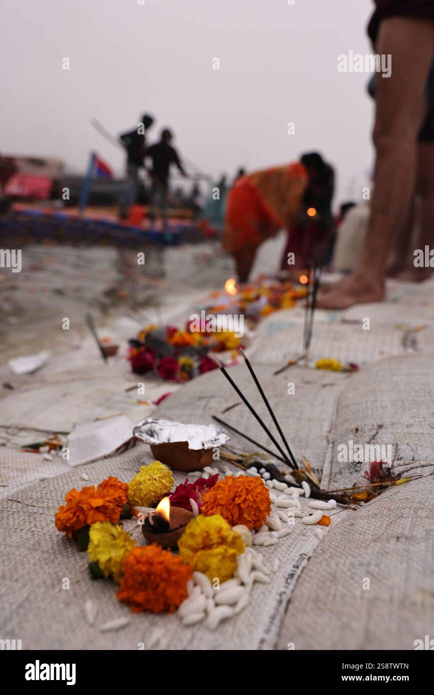 Offering Wicks Wick lamp (diya) and flowers. Offering made at the Sangam during the ...