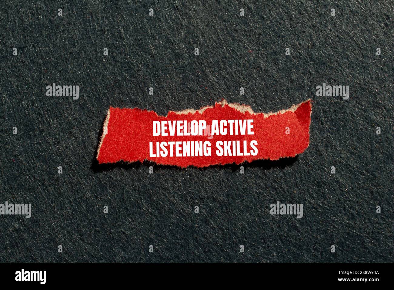Develop active listening skills message written on ripped torn red ...