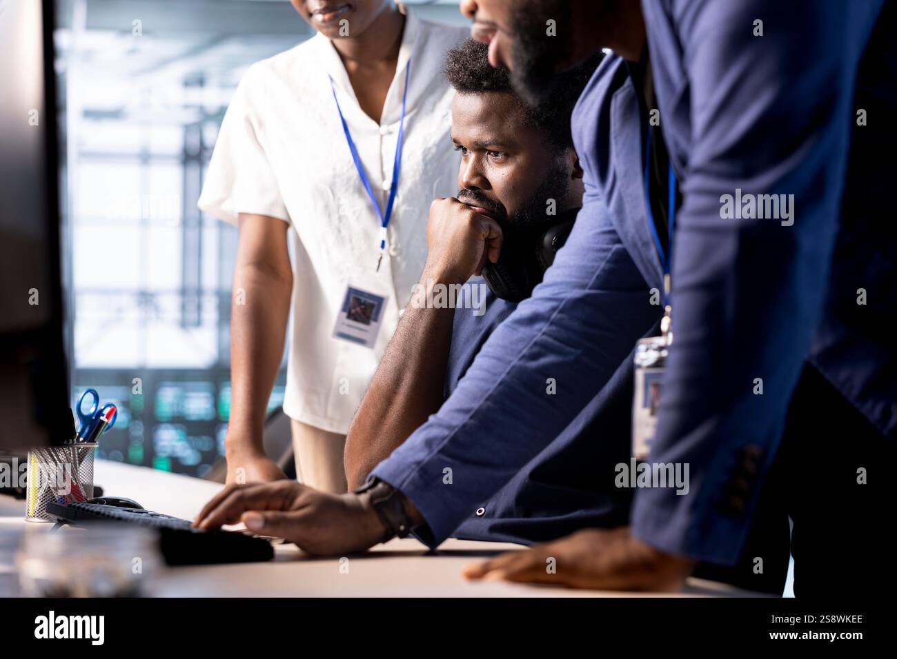 Team of data center program developers creating technical documentation for software applications. System administrators in server room using computer, maintaining databases Stock Photo