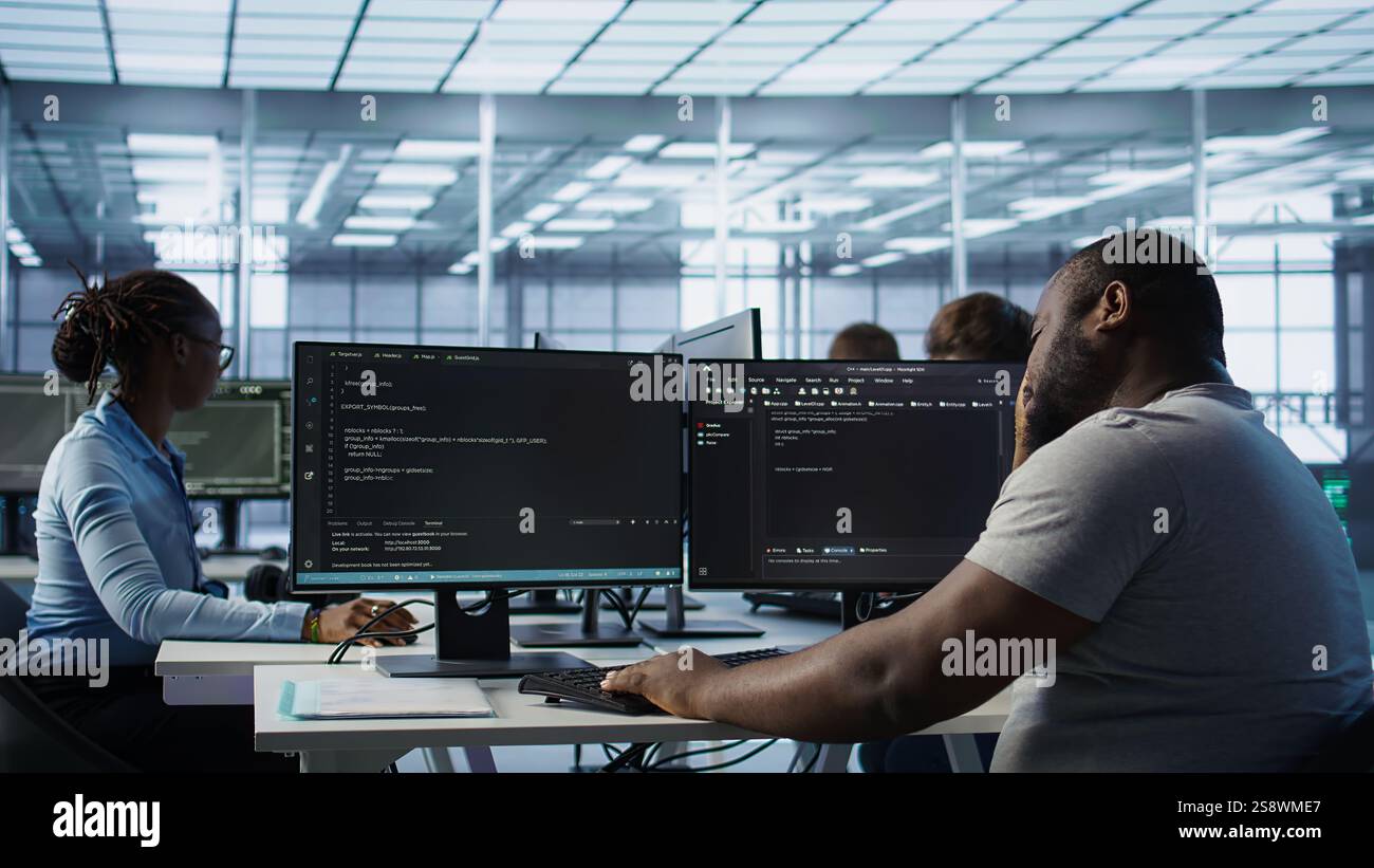 System admin feeling ill, having fever while working in computer network security data center. Sick worker suffering headache while monitoring energy consumption across server racks, camera B Stock Photo