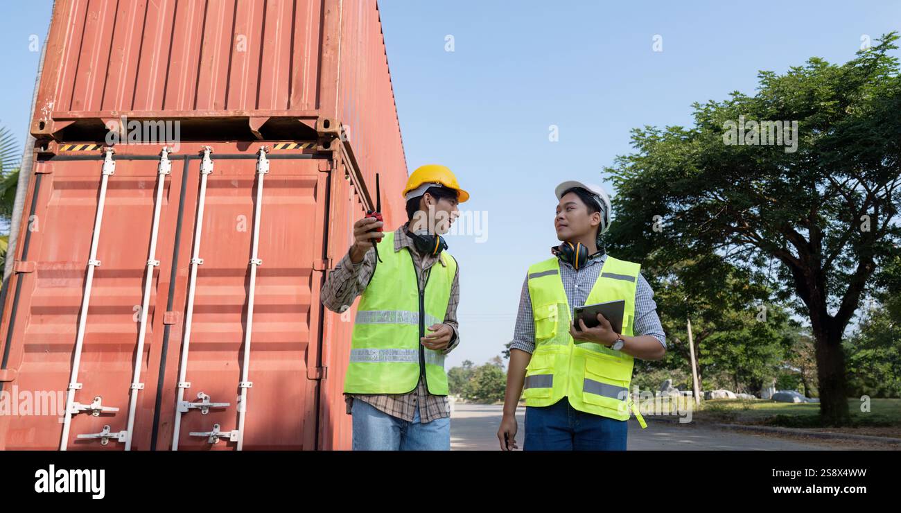 Engineers discussing logistics and container management near shipping ...
