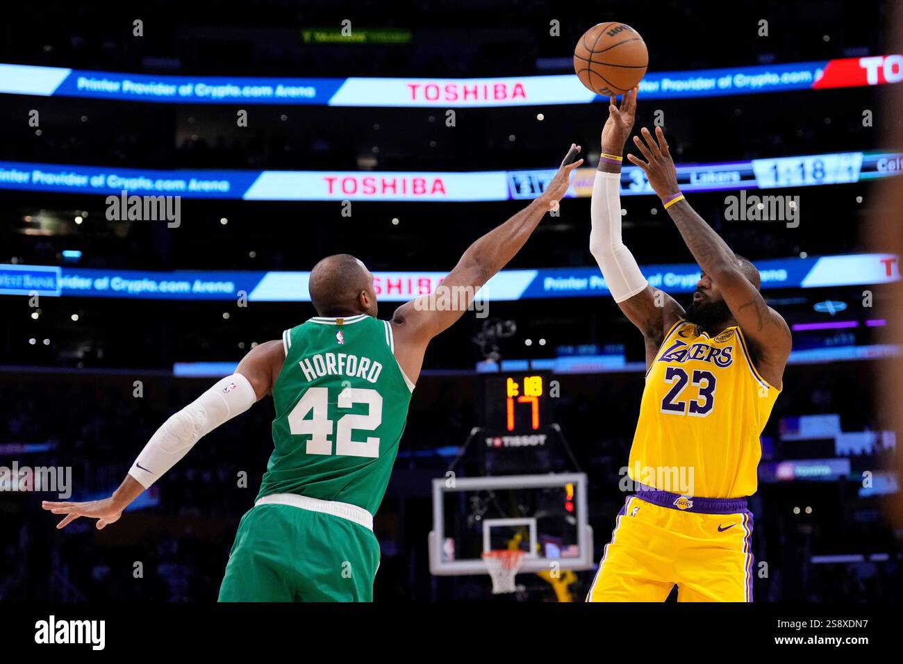 Los Angeles Lakers forward LeBron James, right, shoots as Boston