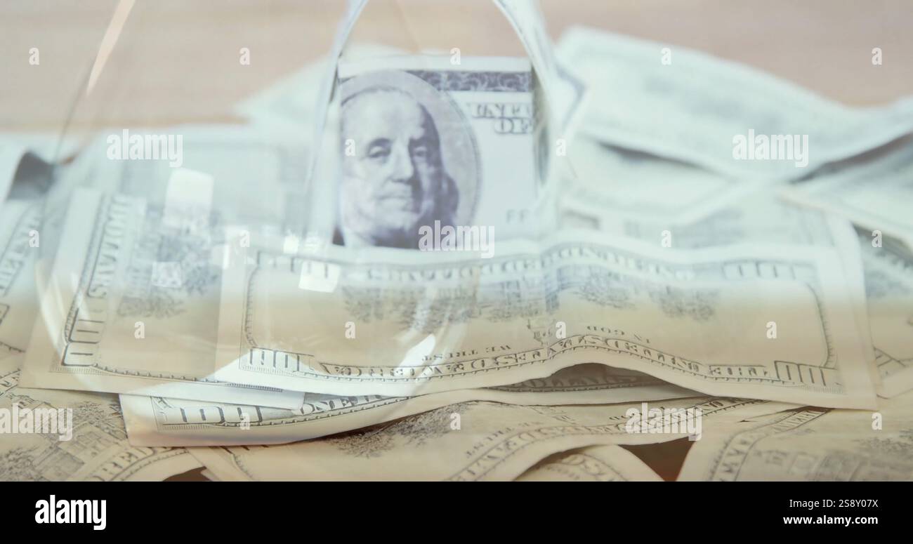 Image of multiple banknotes over hourglass Stock Photo - Alamy