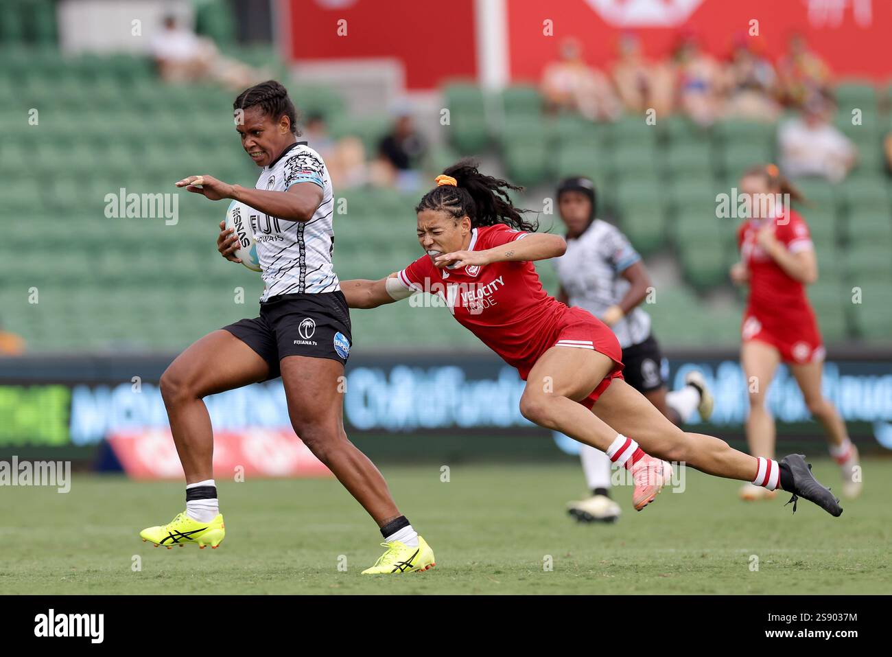 Verenaisi Ditavutu of Fiji is tackled by Asia Hogan-Rochester of Canada ...