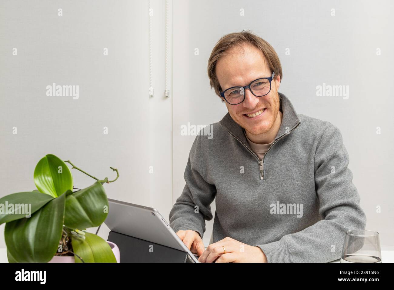 Smiling Entrepreneur Engaged in Work Stock Photo