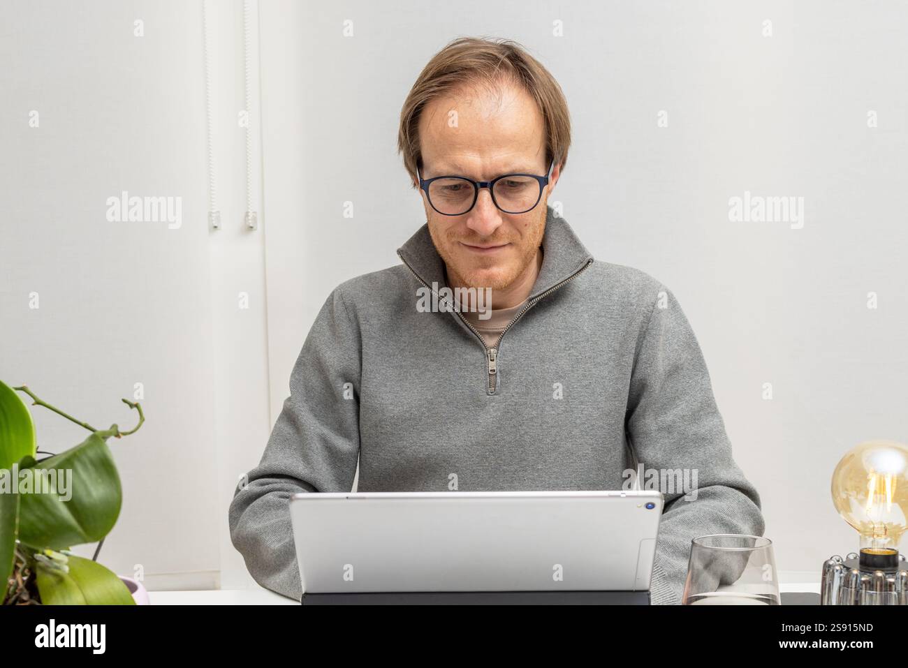 Dedicated Professional Using Technology for his business Stock Photo