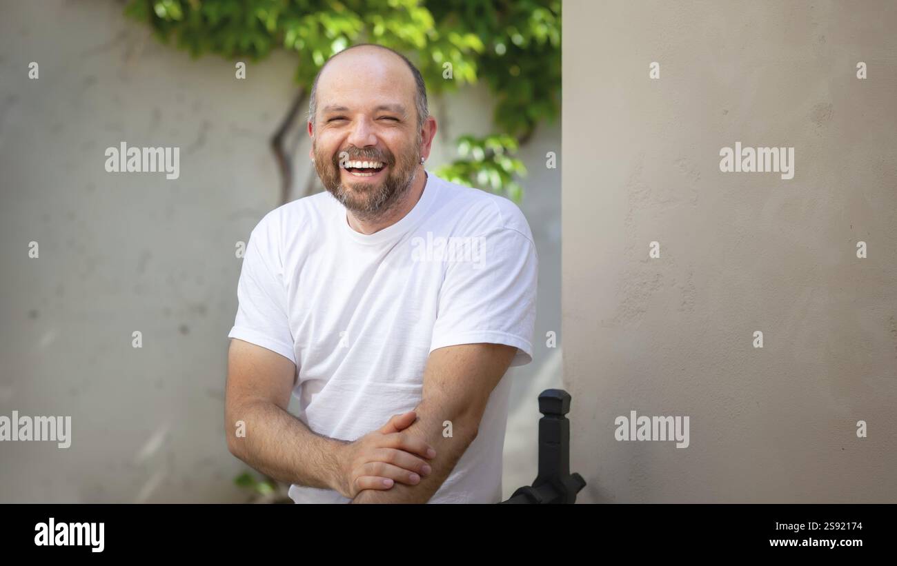 An image of a bearded bald man laughing Stock Photo