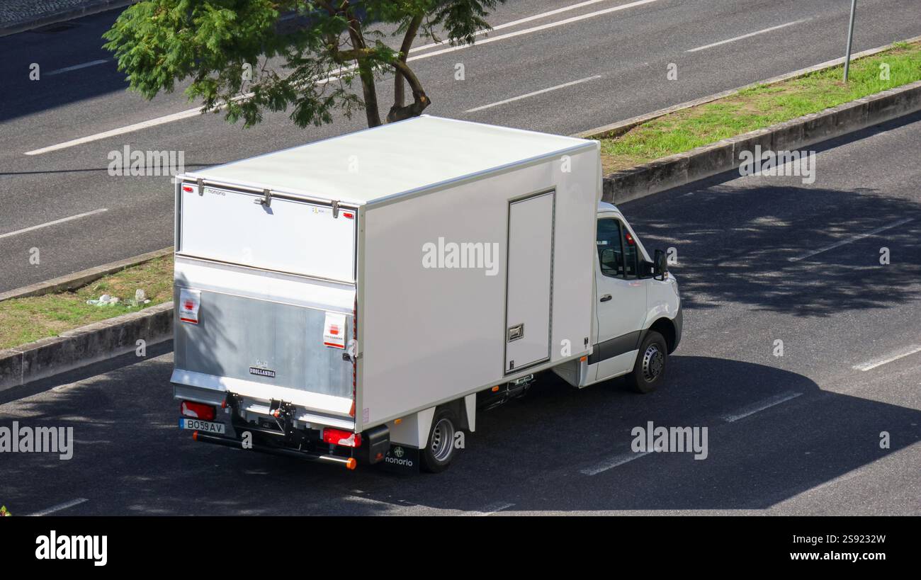 White delivery van transporting goods on a highway, symbolizing ...