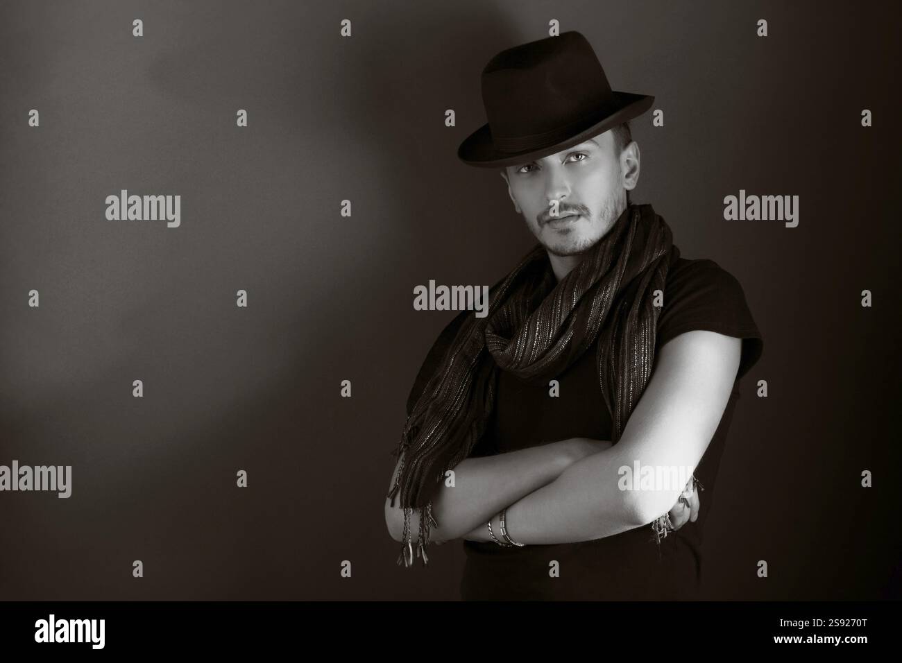Handsome young man posing with hat, monochrome Stock Photo