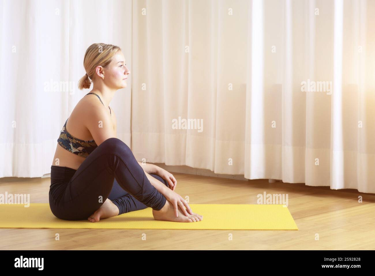 An image of a young woman doing yoga relax position Stock Photo - Alamy