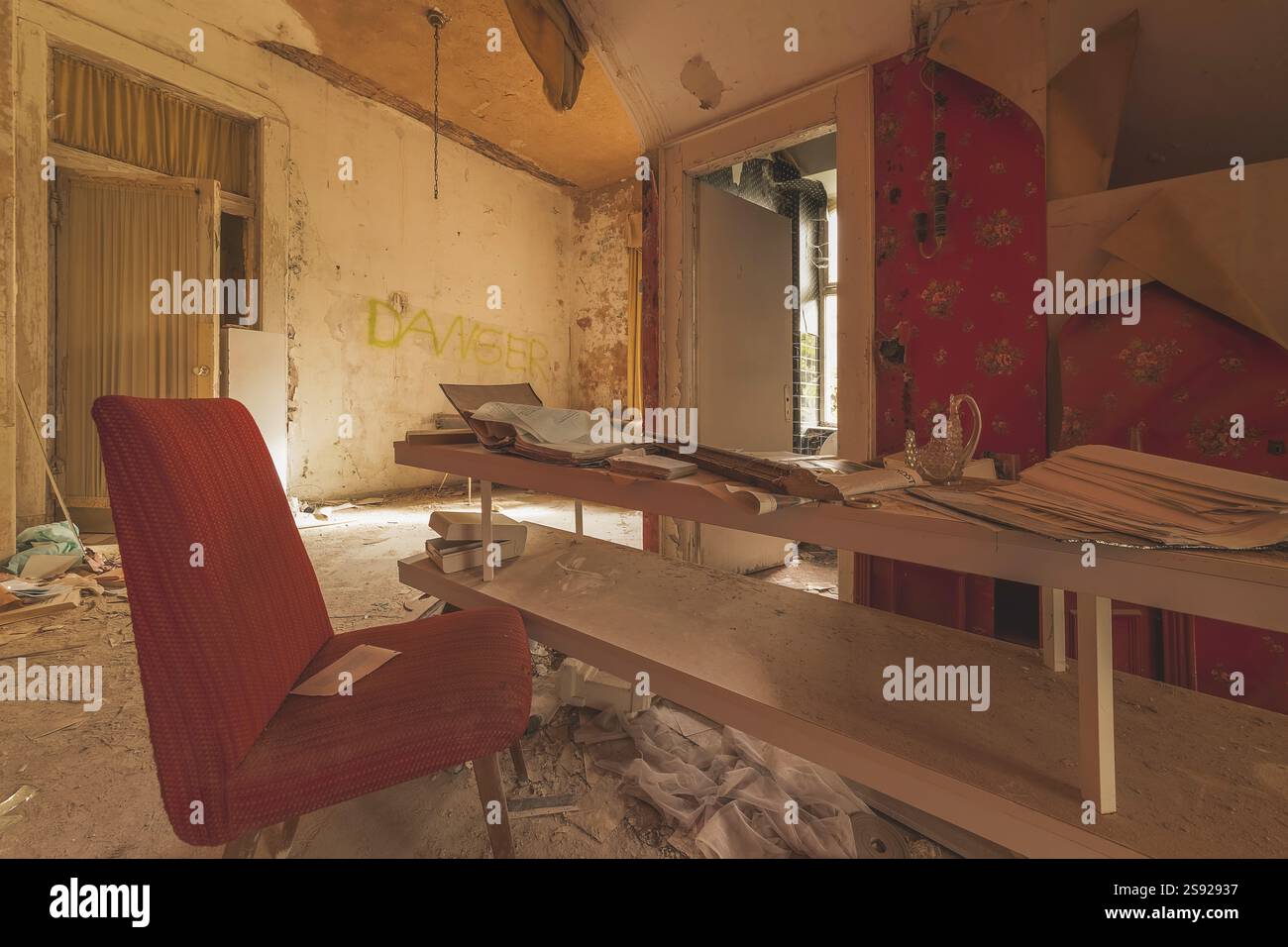 Table Crumbling Abandoned room with a red armchair, dusty table and crumbling walls ...