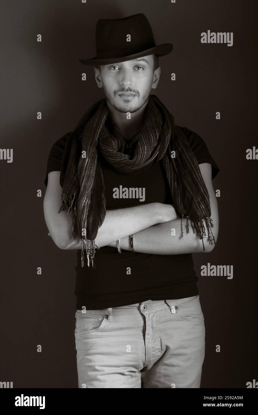Handsome young man posing with hat, monochrome Stock Photo