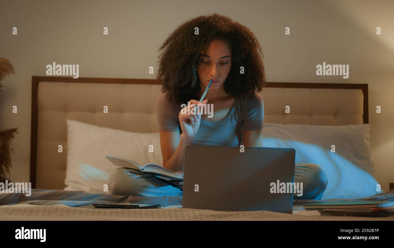 African American woman girl student studying with laptop writing notes ...