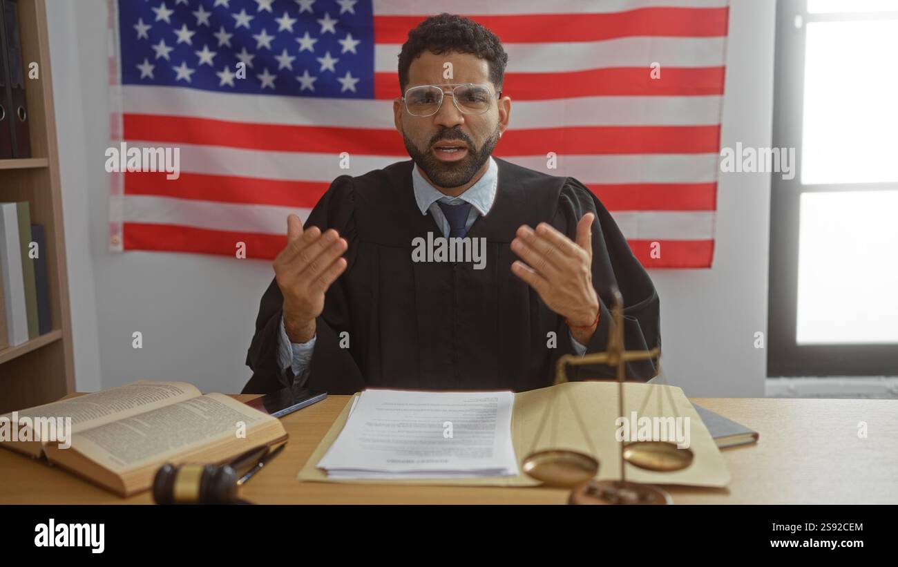 Man in judge's robe discussing in courtroom with american flag in ...