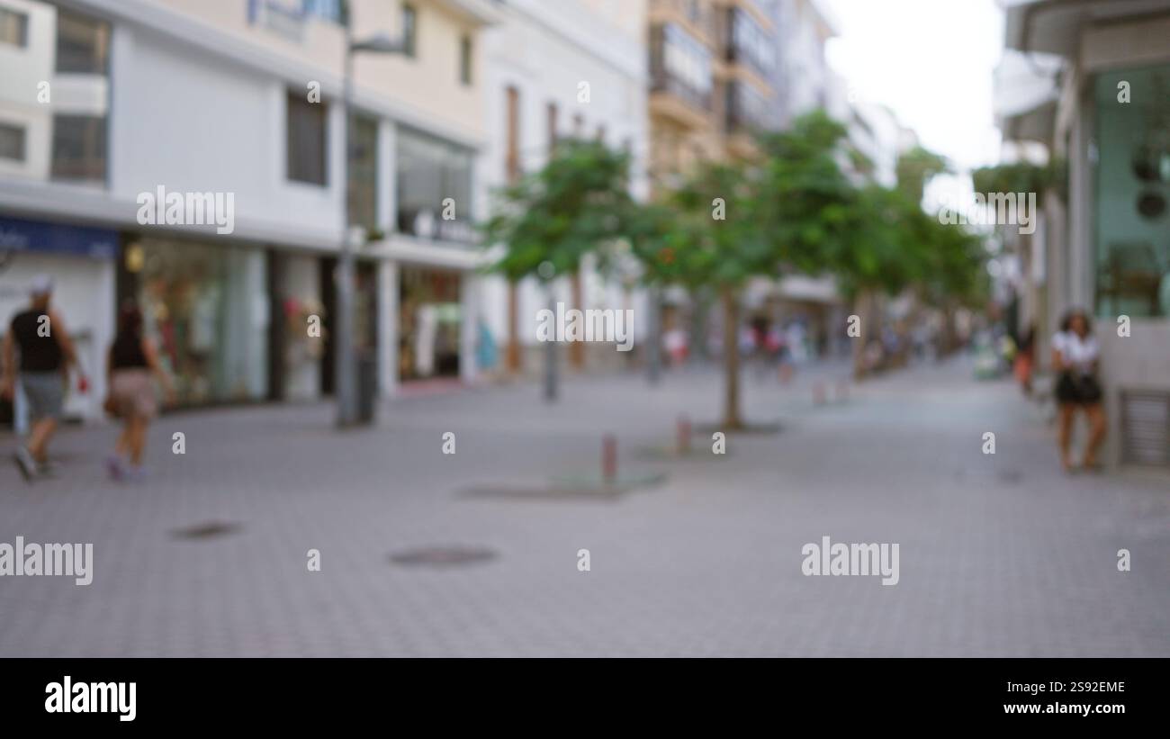 Defocused urban street scene in lanzarote, spain, with blurred people ...