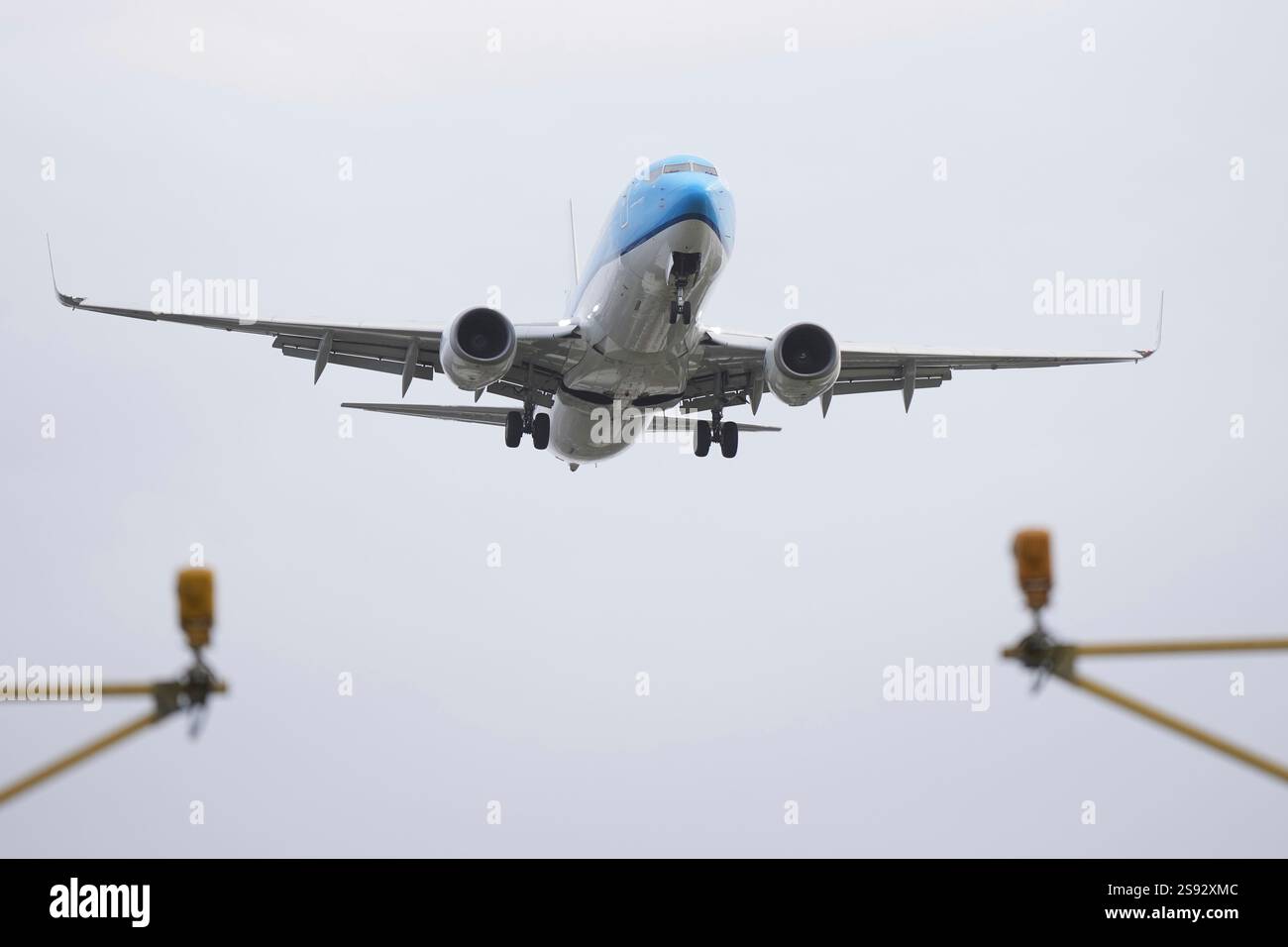 An aeroplane lands in gusty conditions at Heathrow Airport in London ...