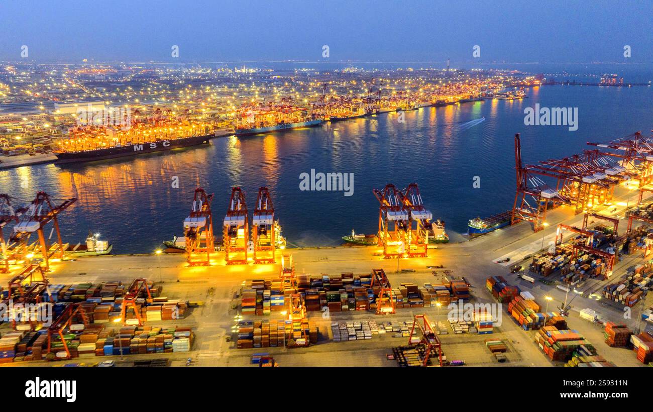 QINGDAO, CHINA - JANUARY 24, 2025 - Container ships dock at the berth ...