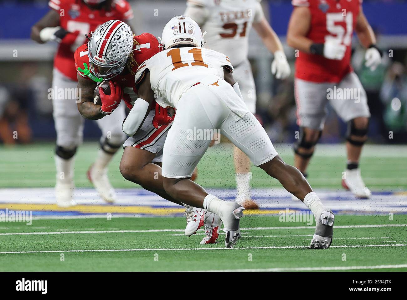 Texas defensive end Colin Simmons (11) tackles Ohio State running back