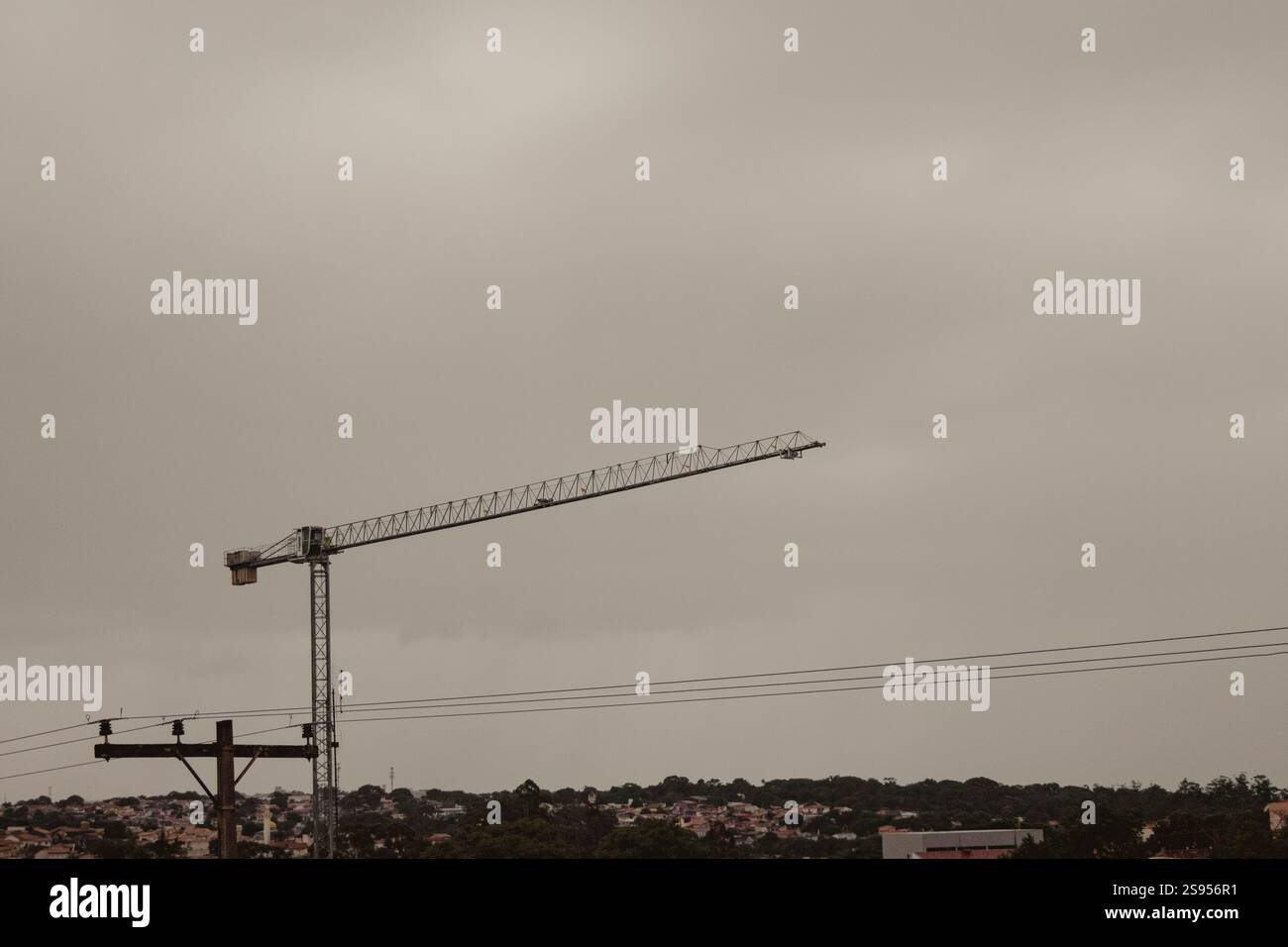 Construction Crane Against Overcast Sky Stock Photo