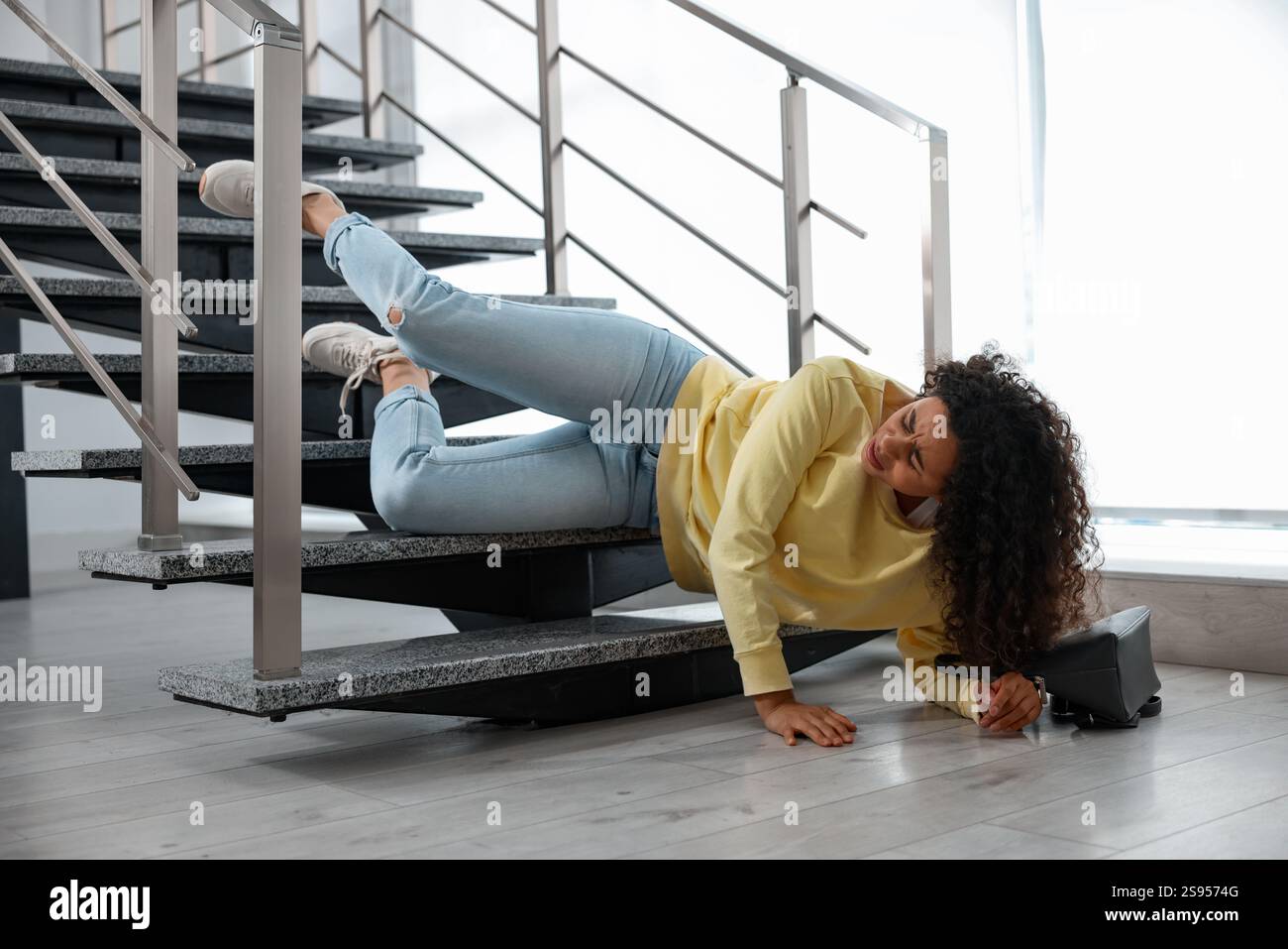 Injured woman on stairs in building after fall. Dangerous accident ...