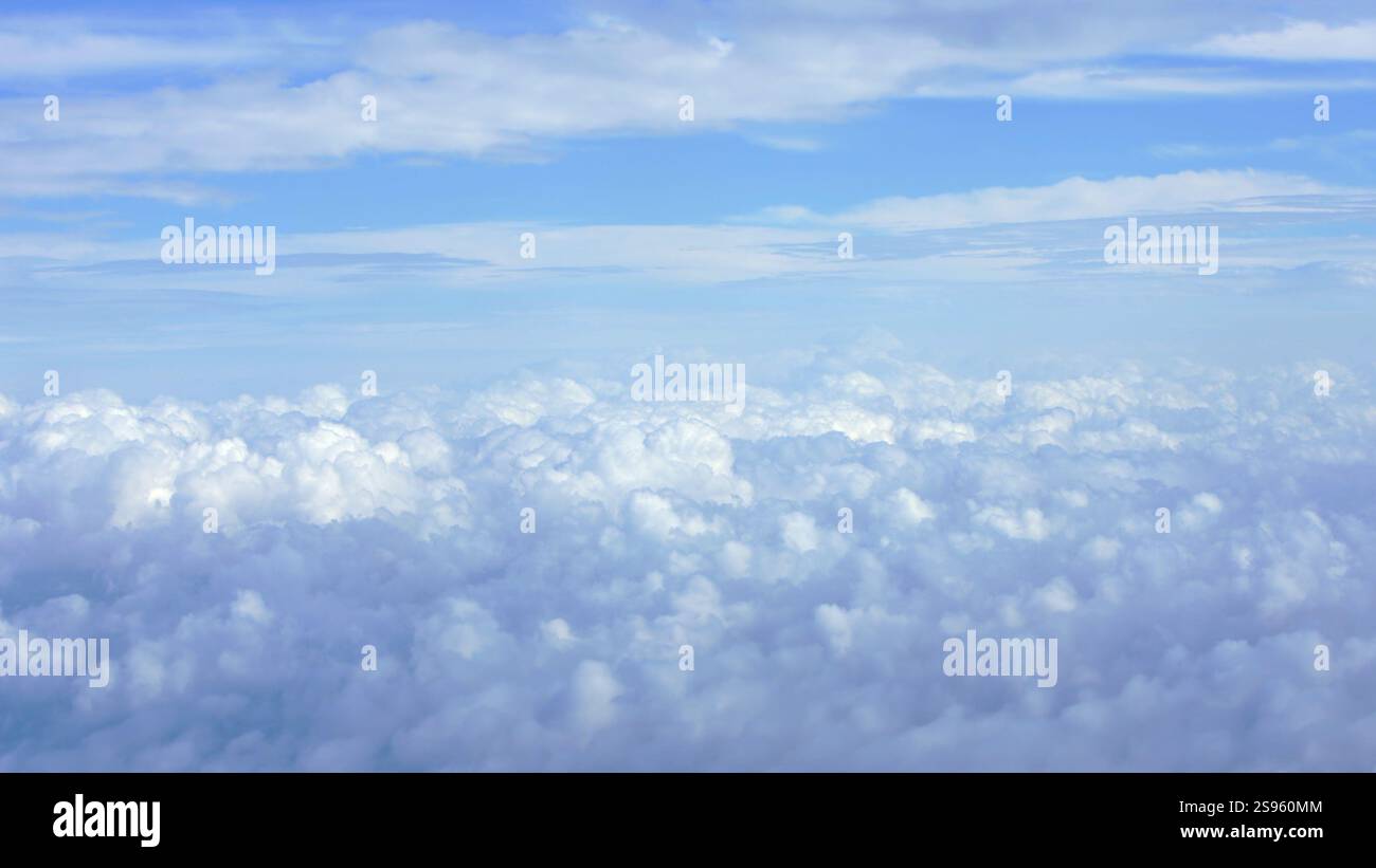 Scenic aerial view of fluffy white clouds with a hint of the Earth ...