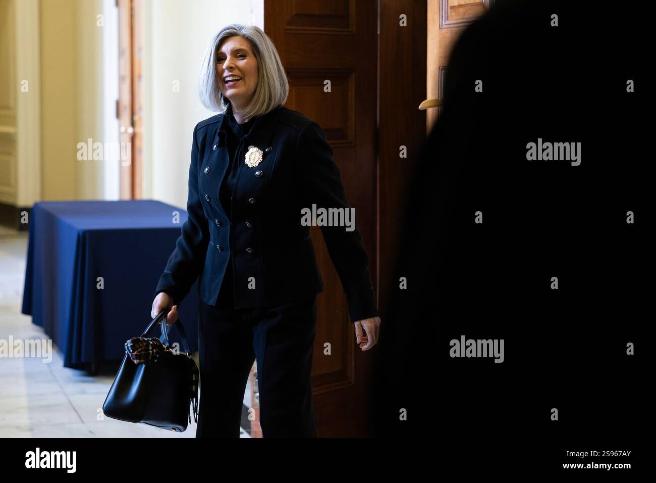 Sen. Joni Ernst (R-Iowa) emerges from a Senate Republican Conference ...