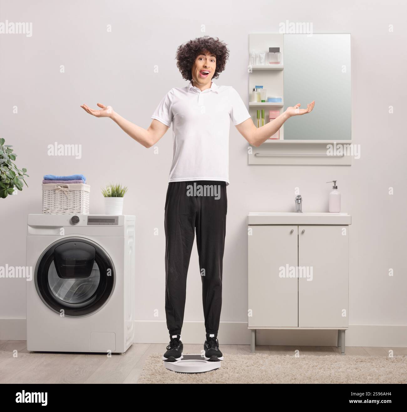 Staning Young man confused about his weight staning on a weight scale in a ...