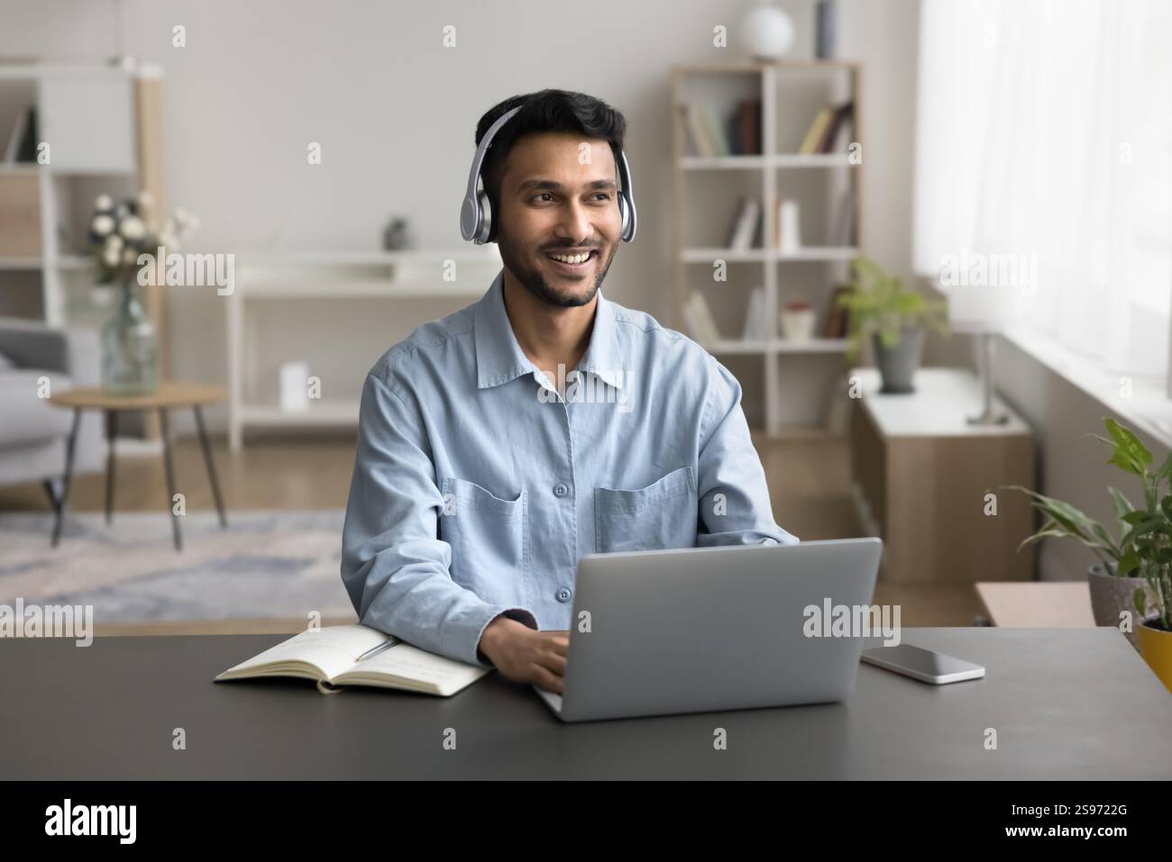 Millennial man using modern tech for successful work from home Stock Photo