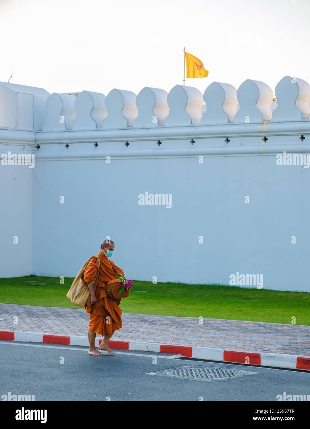Bangkok Thailand 10 January 2025, a monk dressed in vibrant orange ...