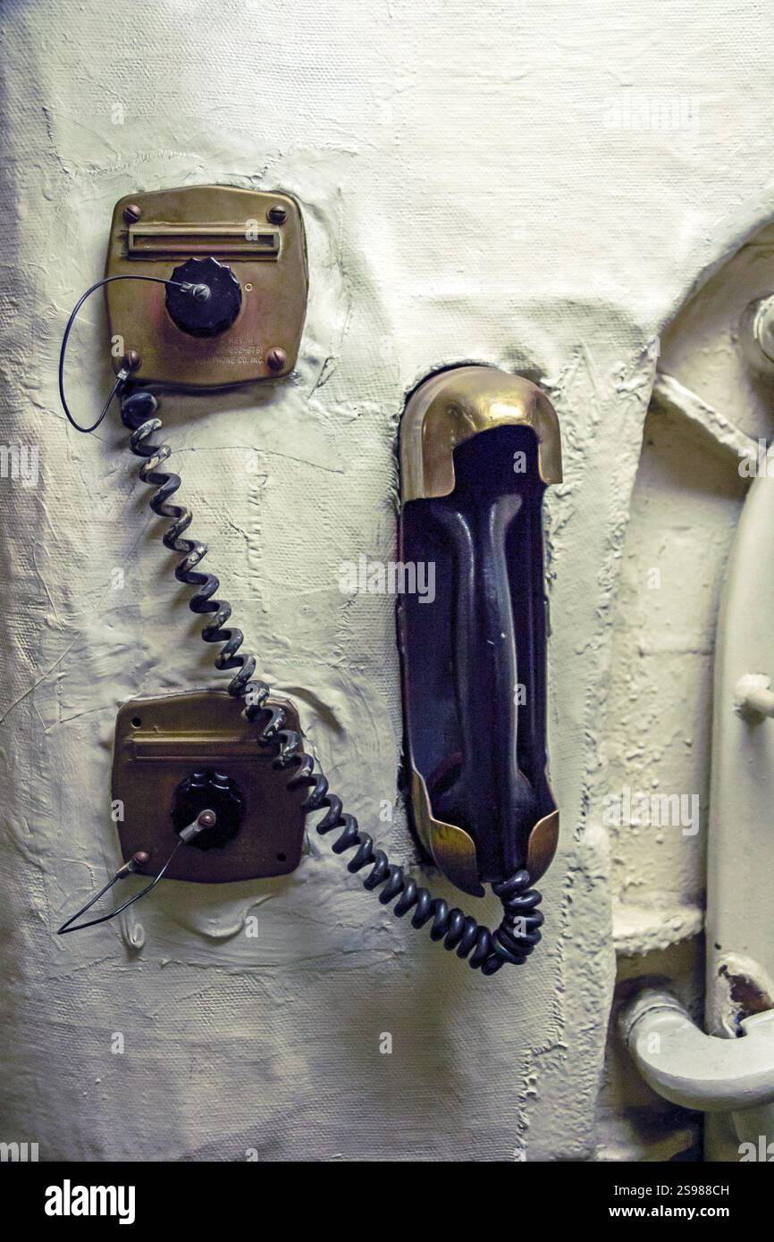 Call With Rope A telephone with a cord hanging from it. The cord is attached to a ...