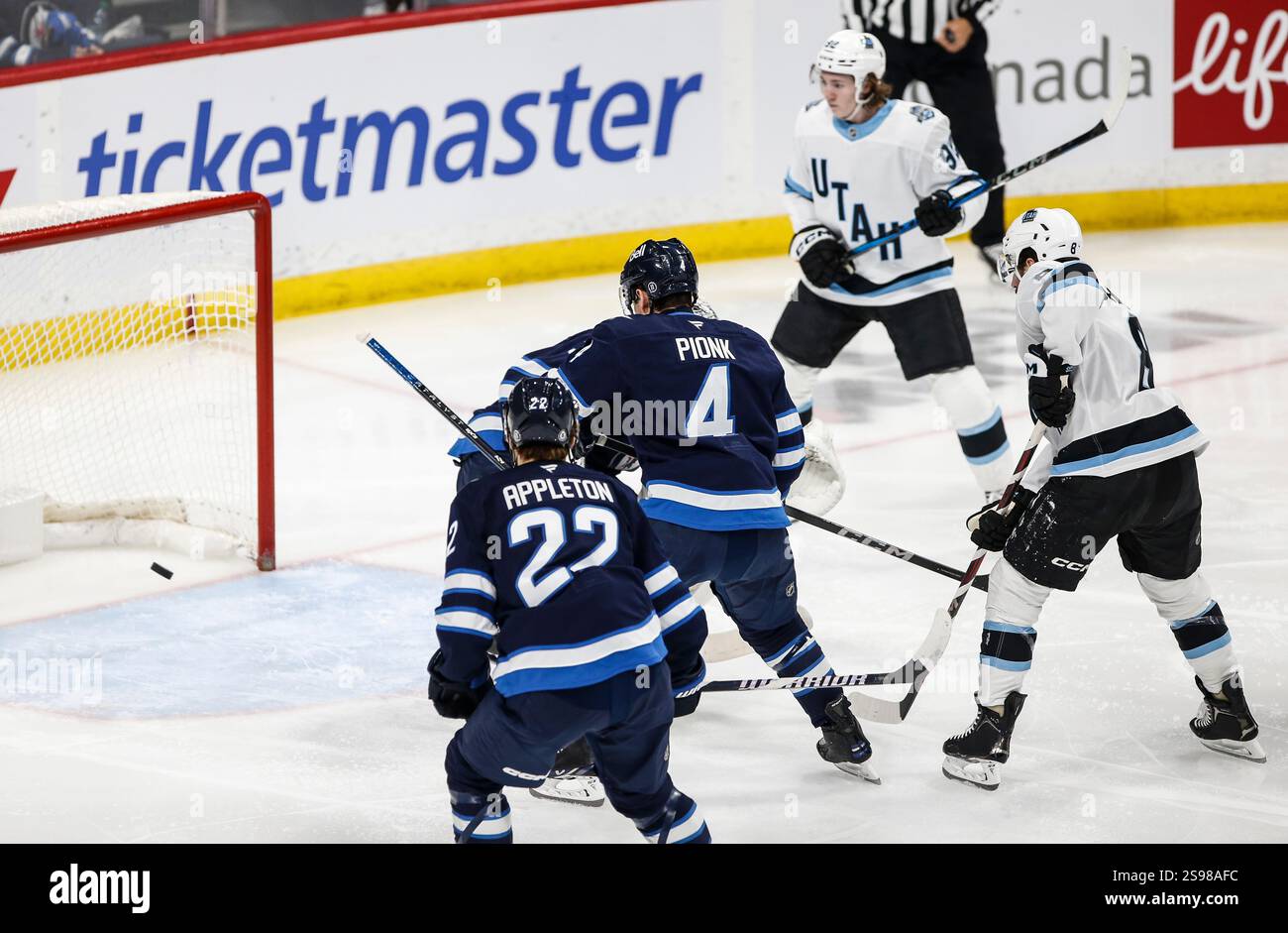 Utah Hockey Club's Nick Schmaltz (8) scores against the Winnipeg Jets
