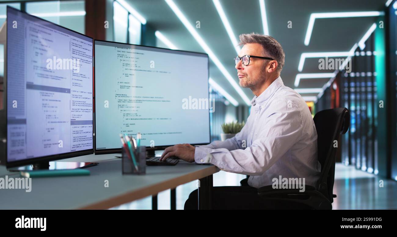 Software Programmer Or Coder Man Using Office Computer Stock Photo