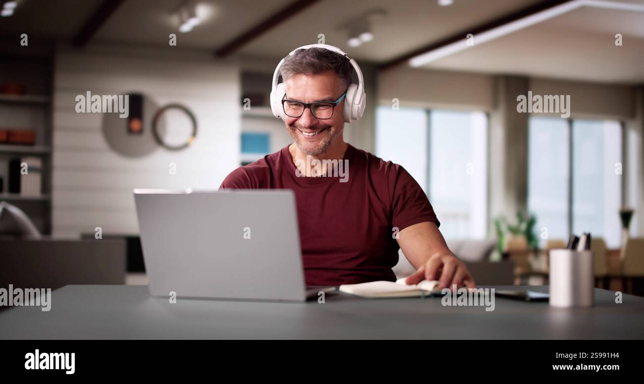 College Teacher At Home Using Laptop Computer Stock Photo