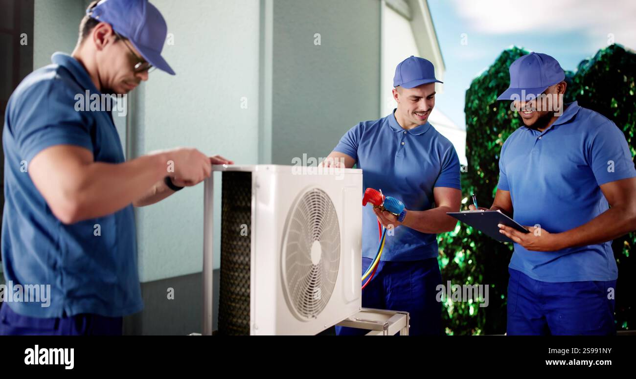 Industrial Air Conditioning Technician repairing black HVAC unit outside. Stock Photo