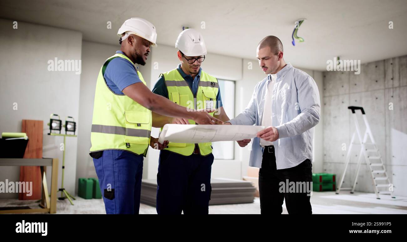 Three professionals inspecting house construction with safety in mind. Stock Photo