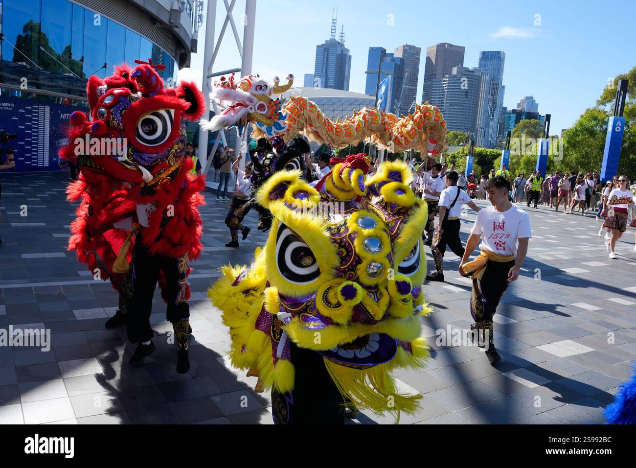 Lion and dragon dancers perform outside Rod Laver Arena to celebrate