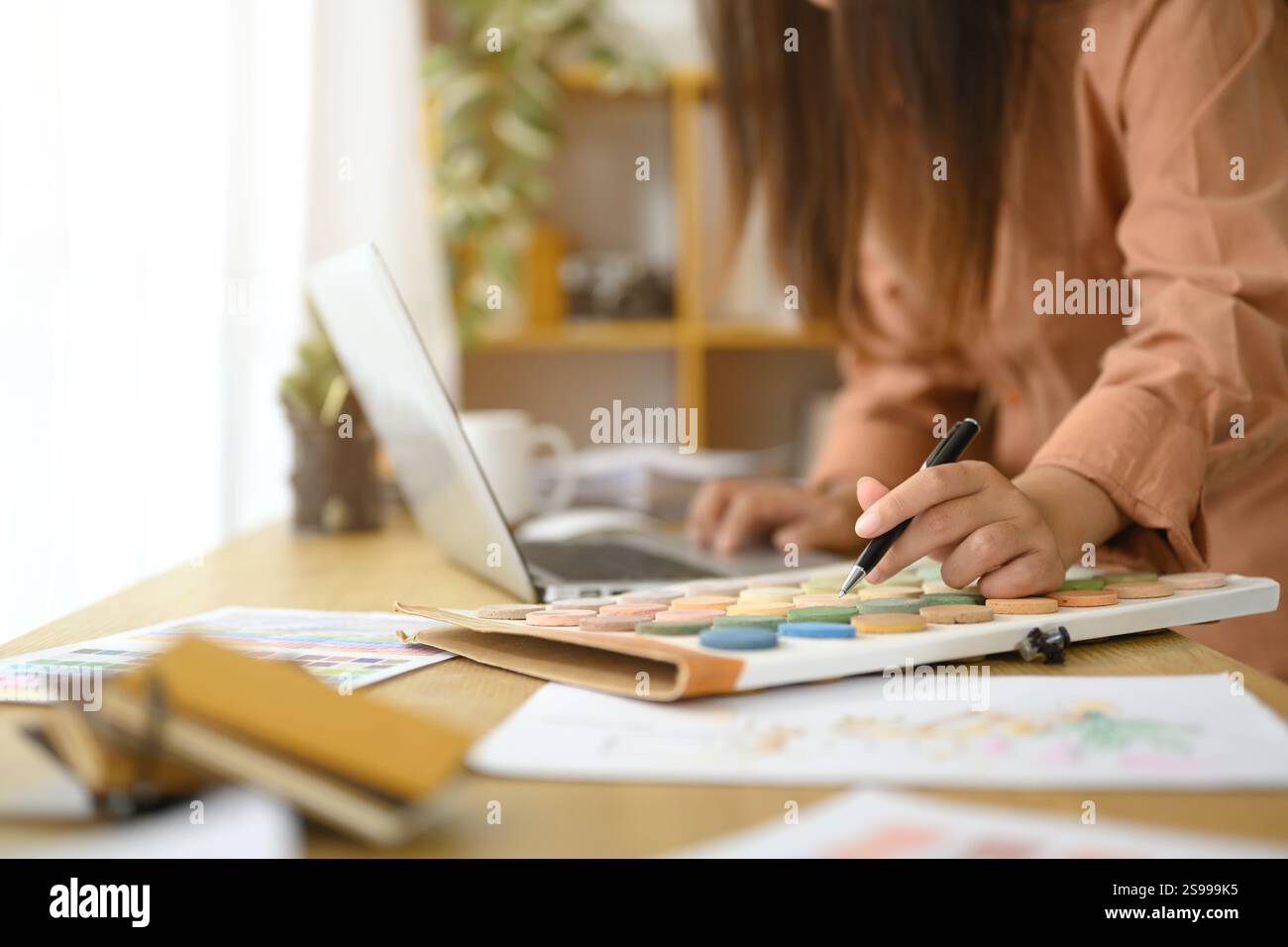 Interior designer selecting and reviewing color swatches while working ...