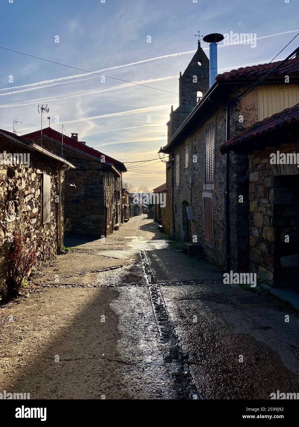 Rabanal del Camino on a Cold Winter's Morning with Blue Sky and Contrails in the Background - Smartphone Captured Stock Image