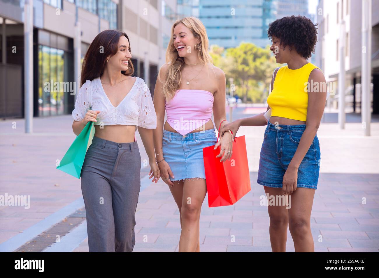 Three Happy Women Shopping and Strolling Outdoors. Stock Photo