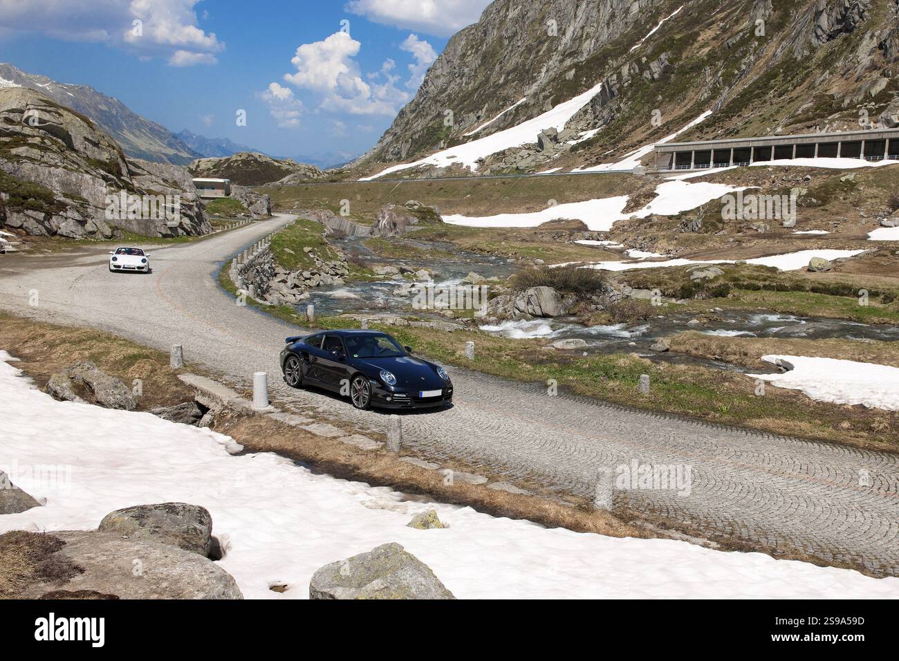 Two Porsche 911 driving on north ramp northern ascent from Hospental to ...