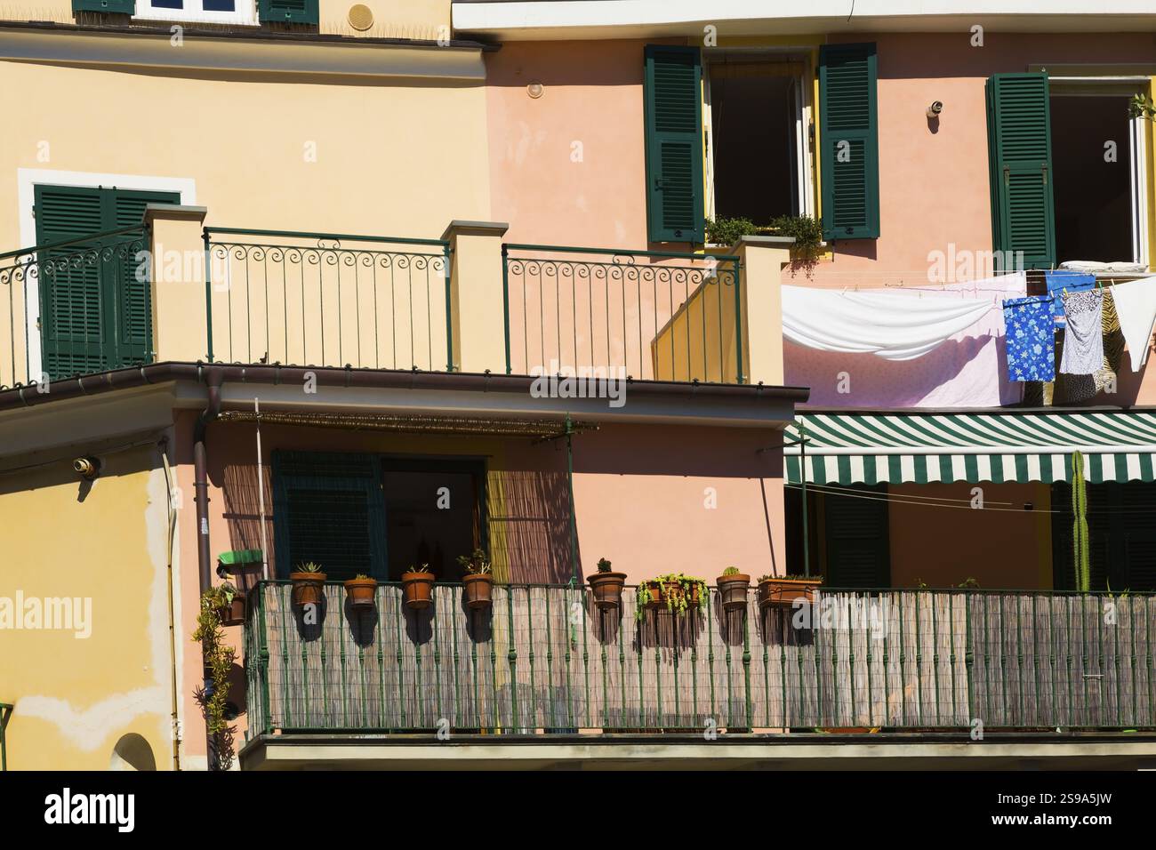 Residential apartment building facade with washed clothes drying on ...