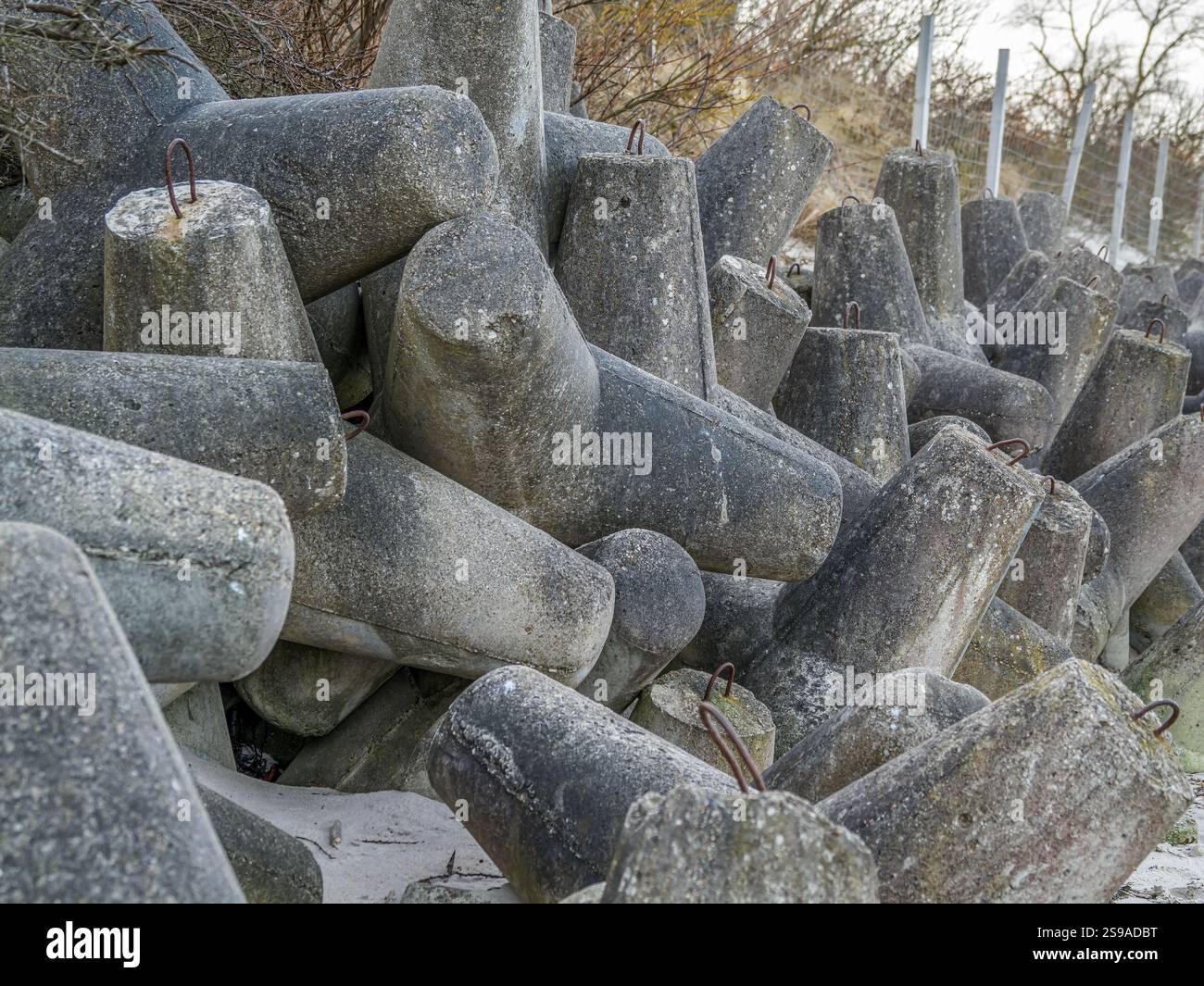 Concrete breakwaters stacked closely together, exhibiting rough ...