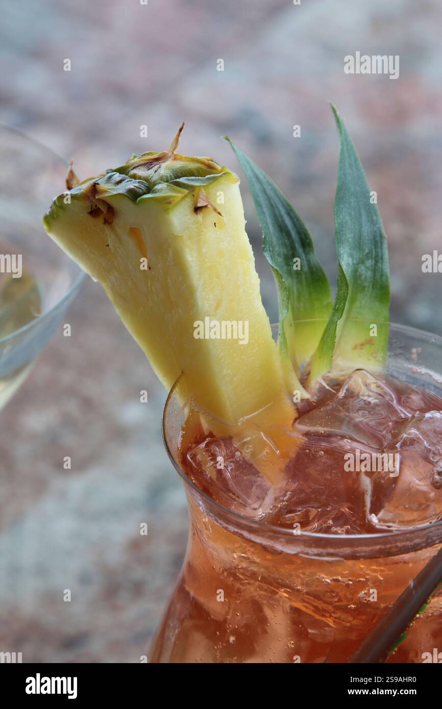 Close-Up of Tropical Drink Garnished with Pineapple Slice Stock Photo