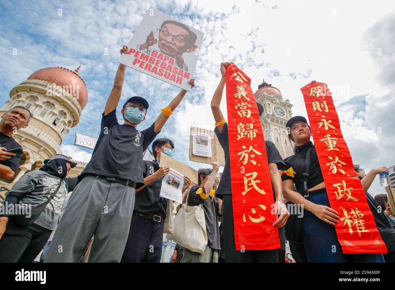 Protesters hold placards and banners during the anti-corruption rally ...