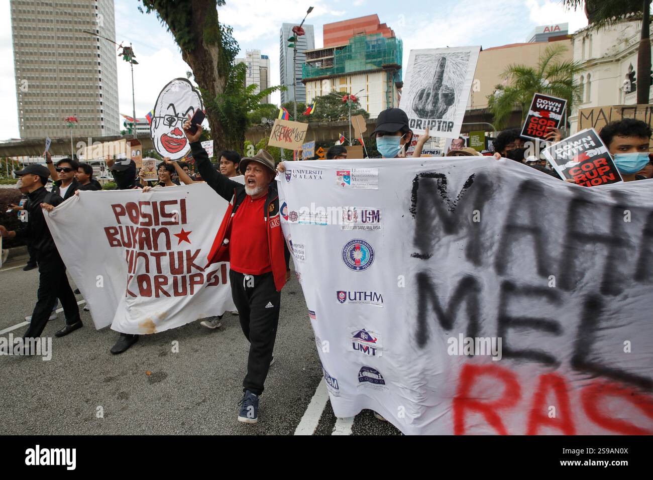 Protesters hold placards and banners during the anti-corruption rally ...