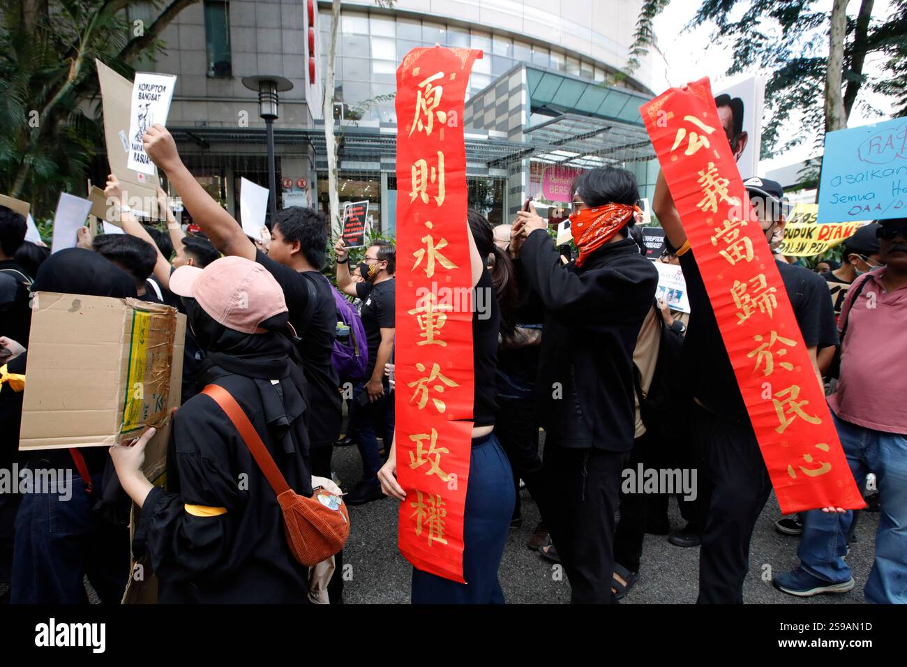 Protesters hold placards and banners during the anti-corruption rally ...