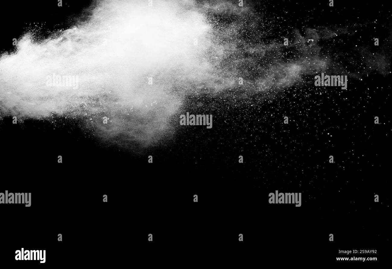 White powder explosion isolated on black background.White dust ...