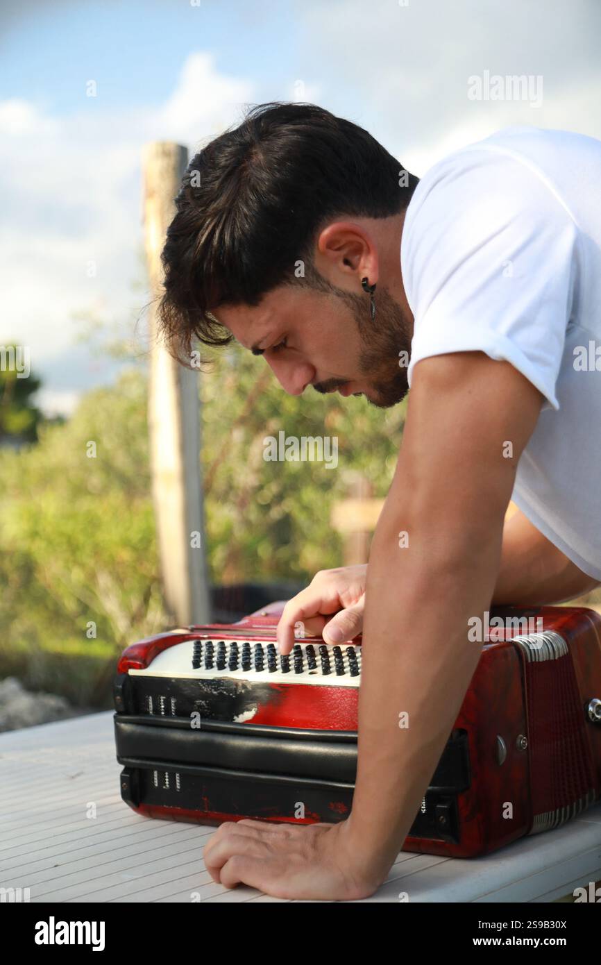 Man Testing All The Buttons Of His Accordion Stock Photo - Alamy