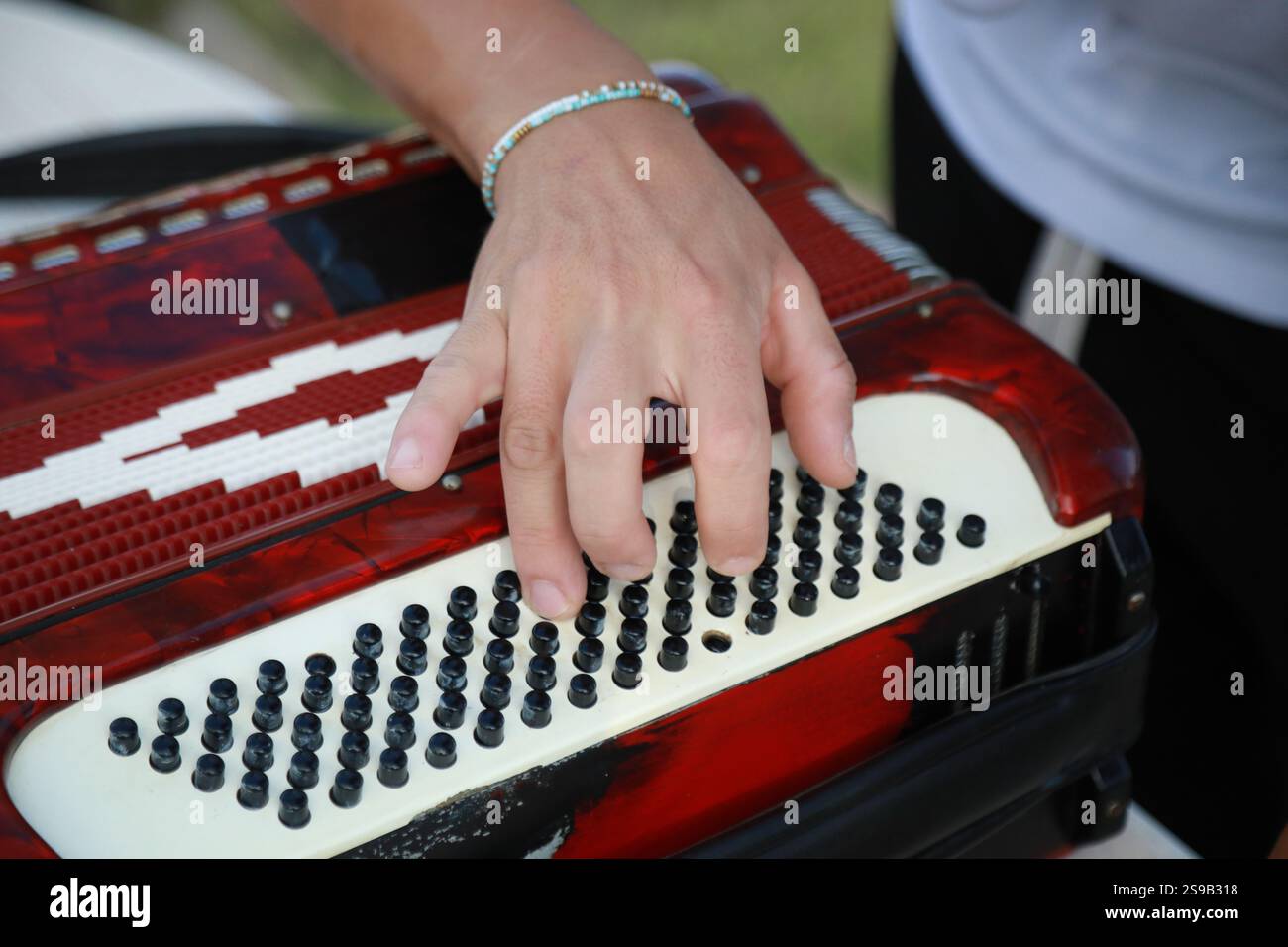 Man Testing All The Buttons Of His Accordion Stock Photo - Alamy